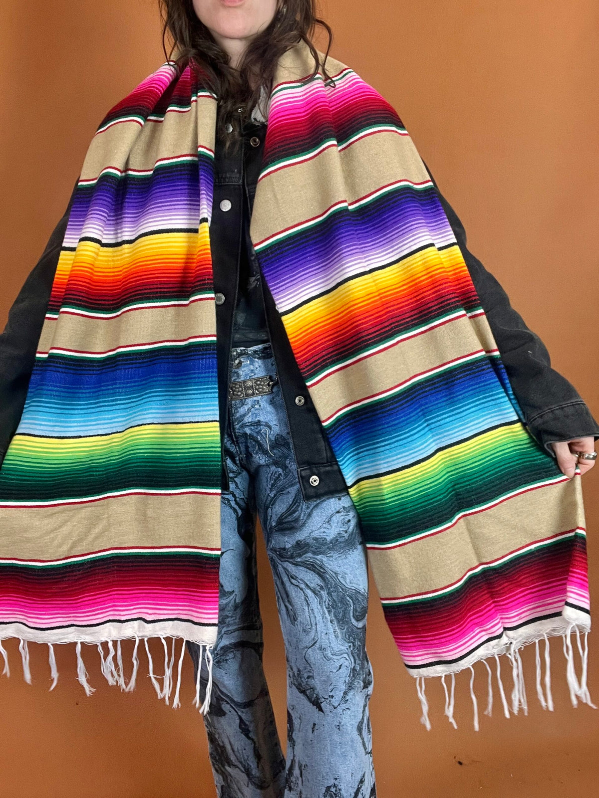 A person wearing a colorful blanket.