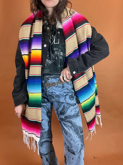 A person wearing a colorful blanket.