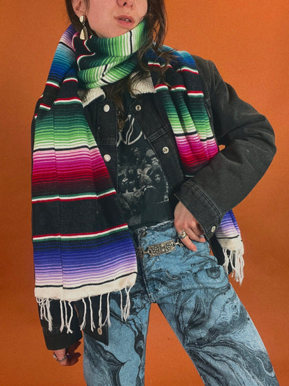 A woman wearing a colorful mexican scarf.