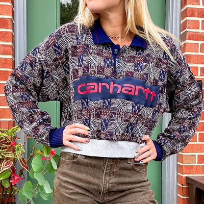 A blonde woman wearing a carhartt sweatshirt.