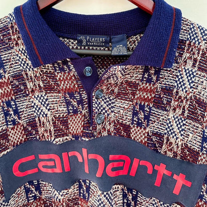 A carhartt polo shirt hanging on a hanger.