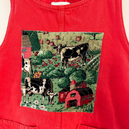A red apron with cows on it.