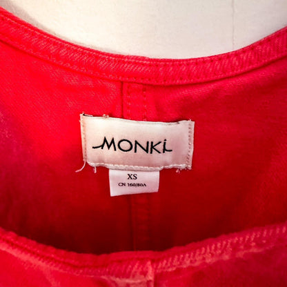 A red monk label on a mannequin.