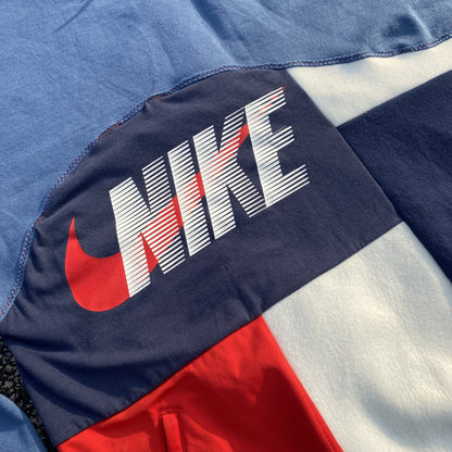 A close up of the nike logo on a blue and red sweatshirt.