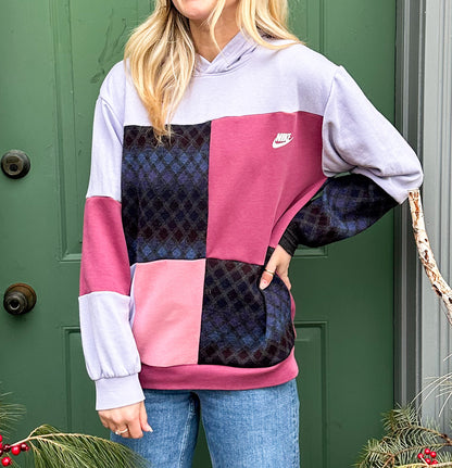 A woman wearing a pink and purple nike hoodie.