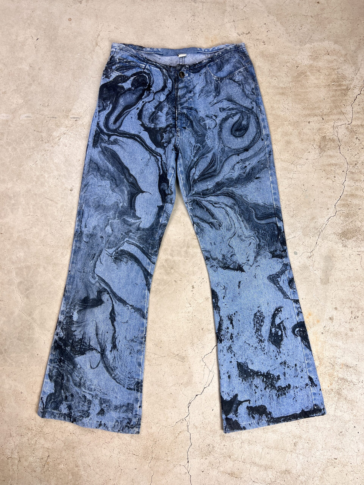 A pair of blue jeans with a black and white print.