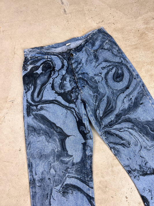 A pair of blue jeans with a marble pattern on them.