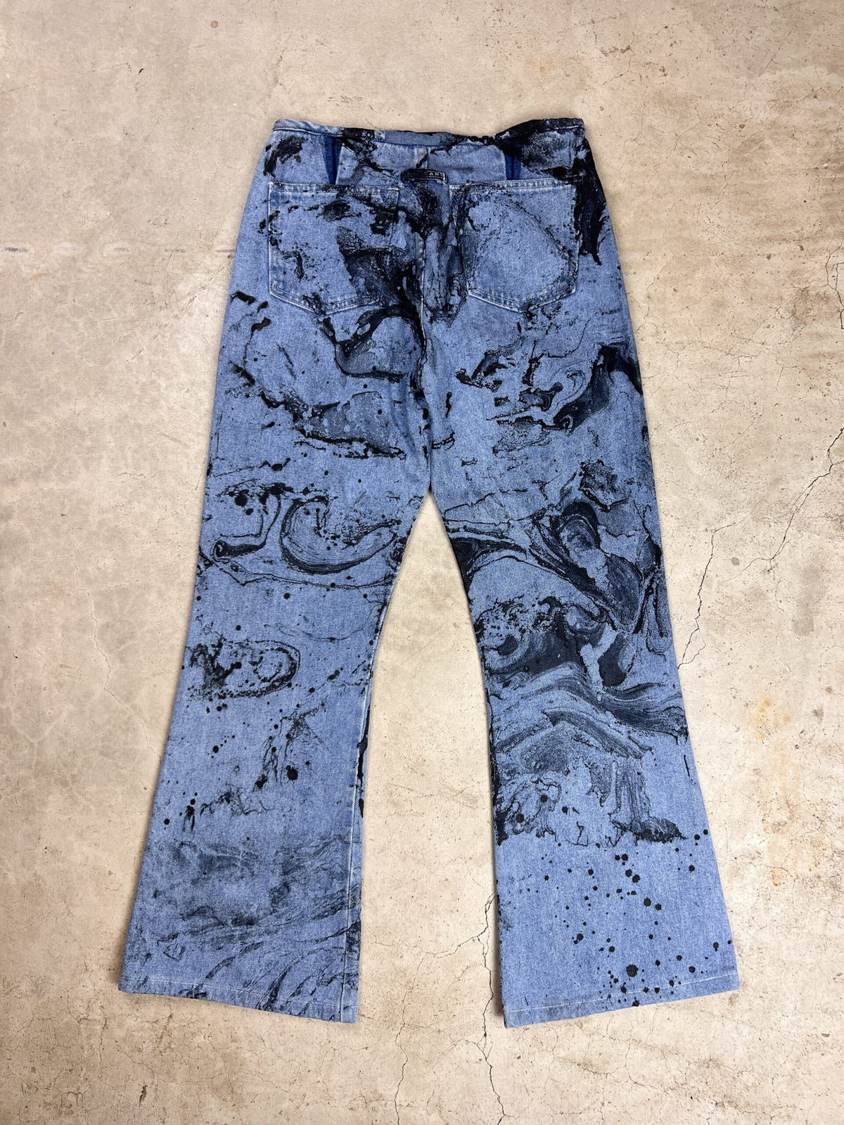 A pair of blue jeans with a black and white print.