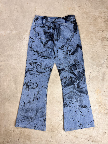 A pair of blue jeans with a black and white print.