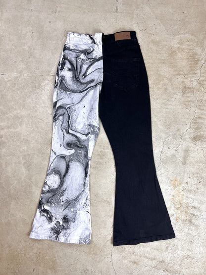 A pair of black and white flared jeans.