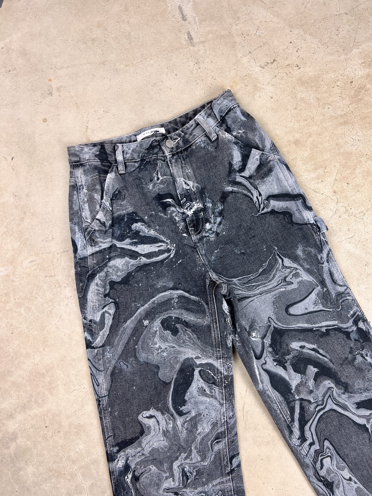 A pair of black and white marbled pants.