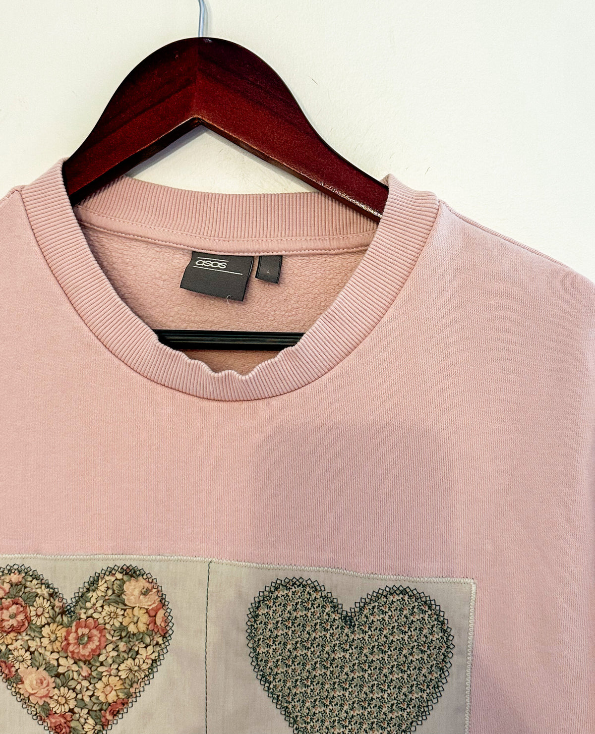 A pink sweater on a swinger.