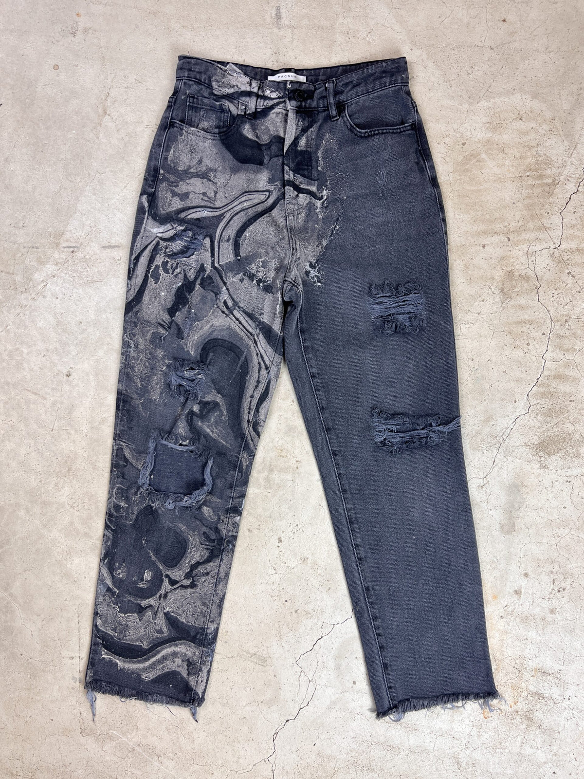 A pair of jeans with a black and white pattern.