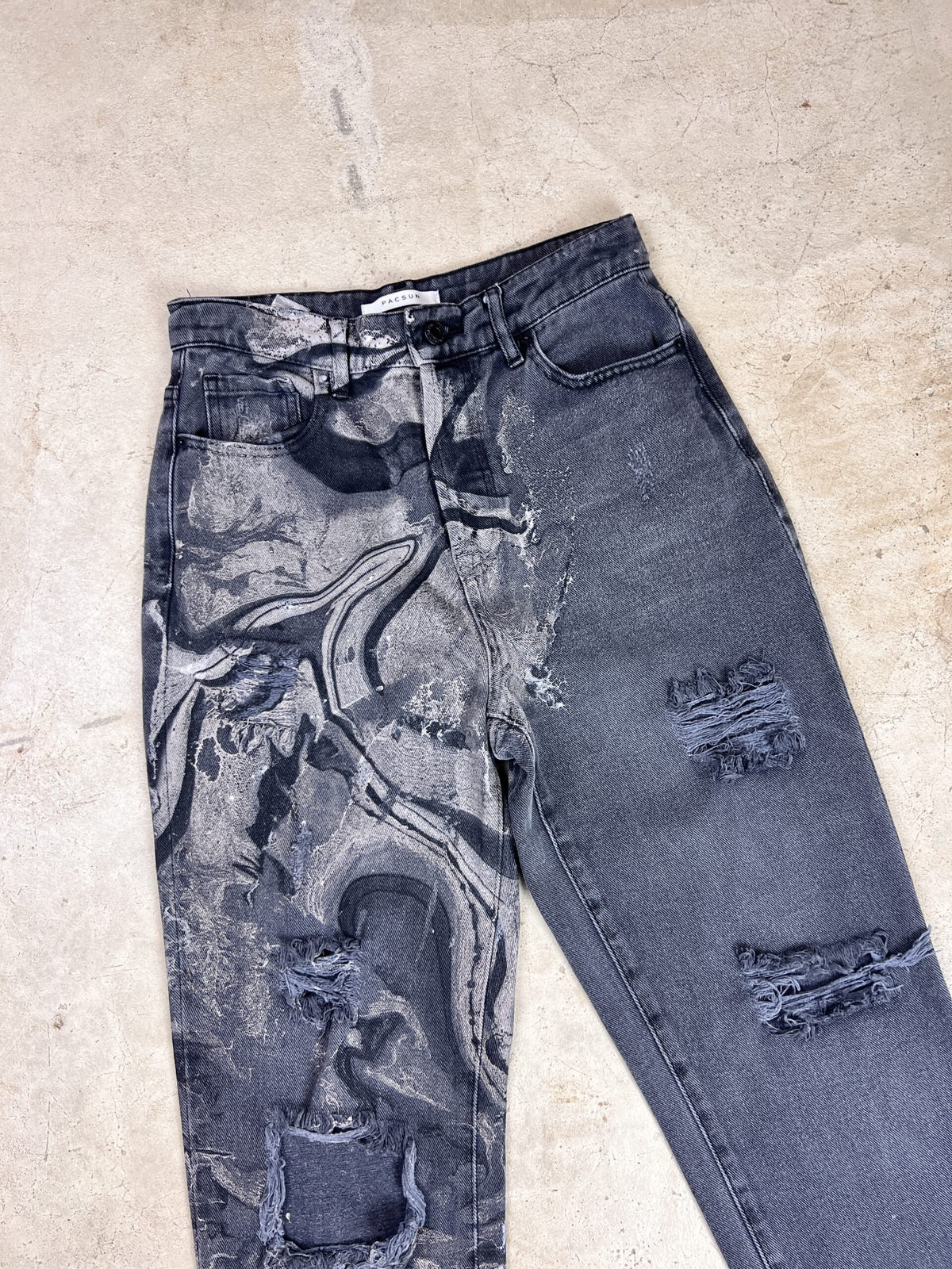 A pair of jeans with a black and grey pattern.