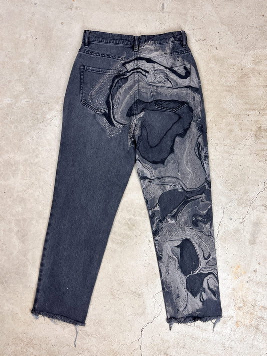 A pair of black and gray jeans with a marble pattern.