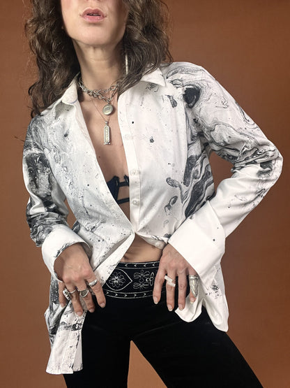 A woman wearing a white shirt and black pants.
