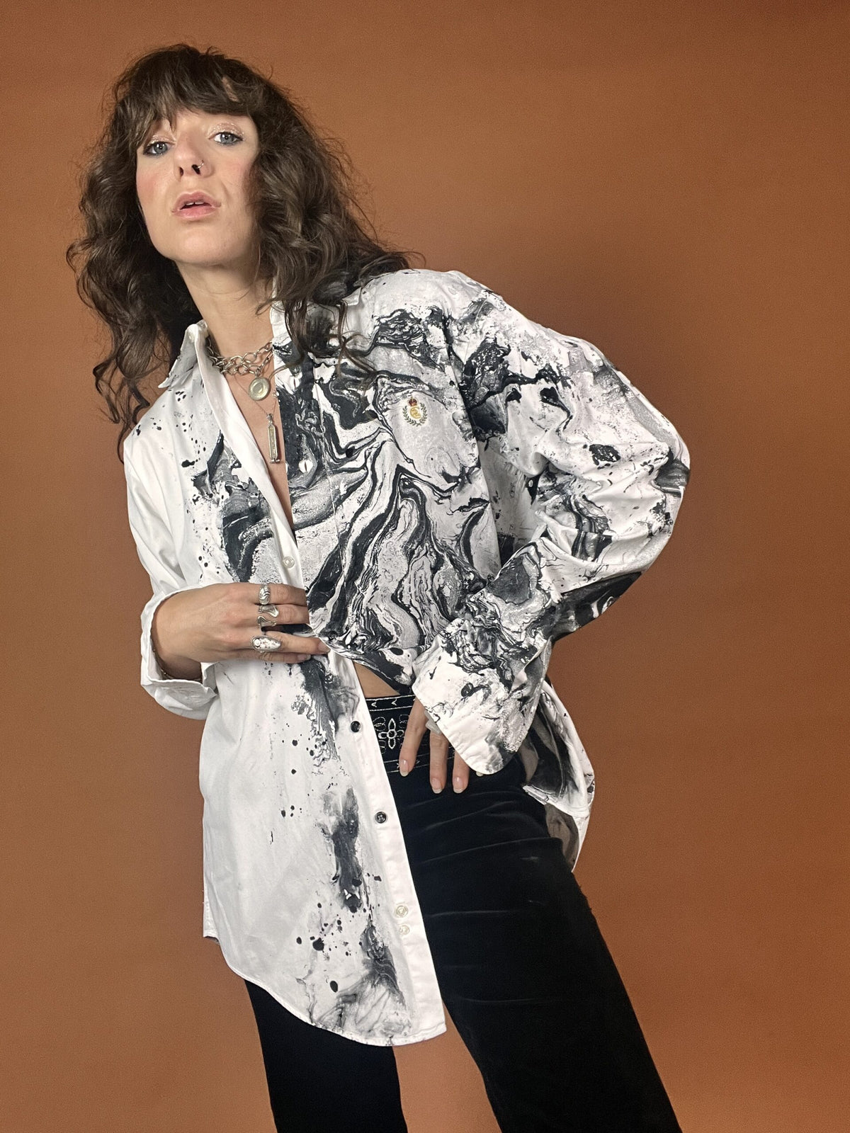 A woman wearing a white shirt and black pants.