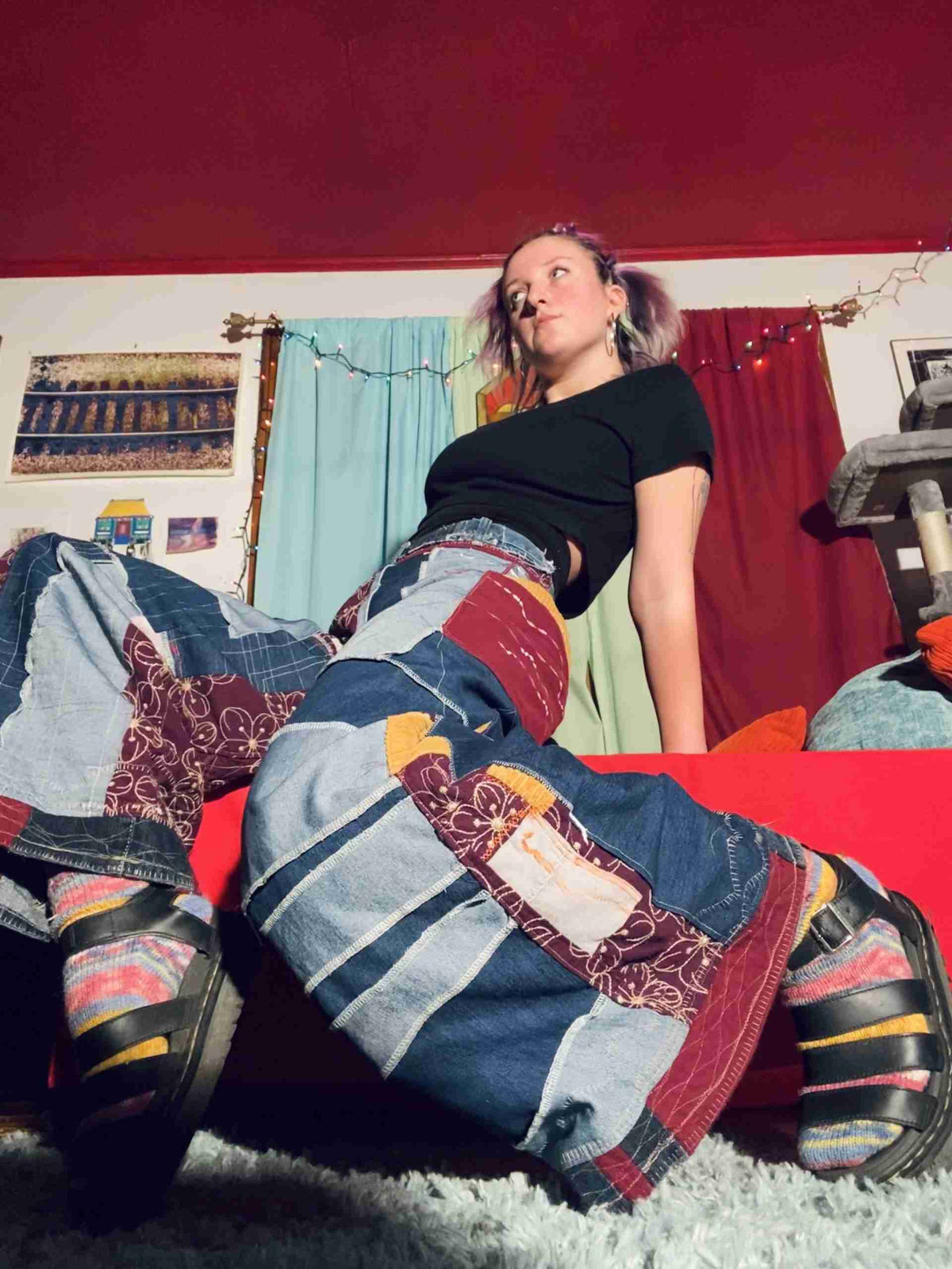 a woman laying on top of a bed in a room.