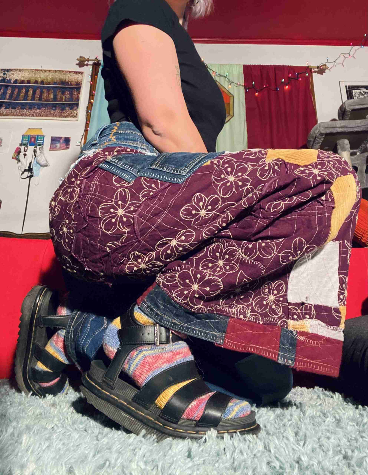 a woman sitting on the floor with her legs crossed.