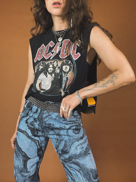 A woman wearing an acdc t - shirt and jeans.