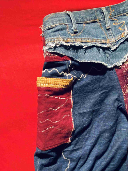 a pair of jeans with different colored patches on them.