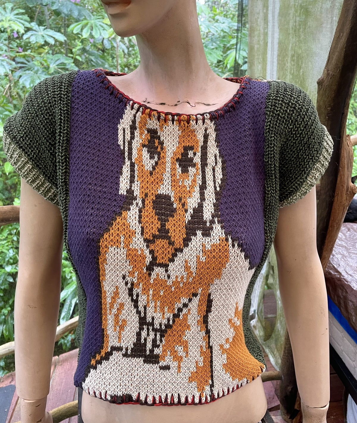 a mannequin wearing a sweater with a dog on it.