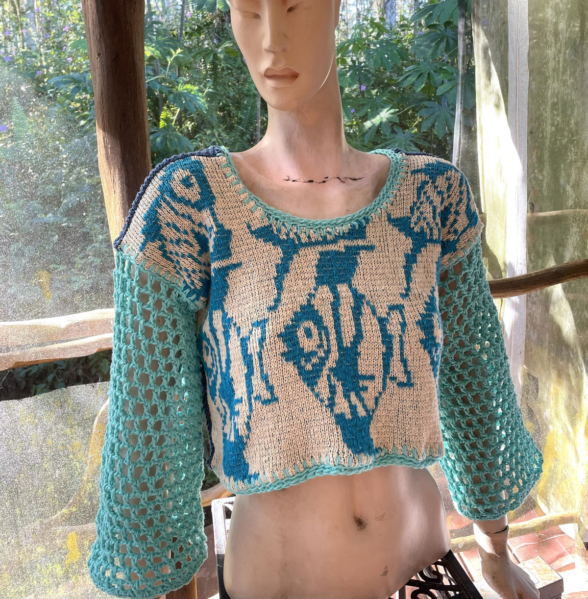 a mannequin wearing a blue and white sweater.