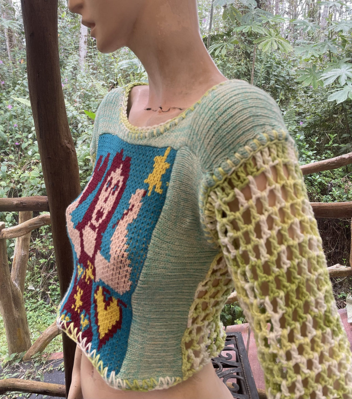A mannequin wearing a Fairy sweater in the woods.