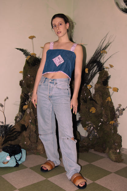 A woman wearing an Upcycled Denim Crop Top, Vintage Purple Bandana Straps, S/M and jeans.