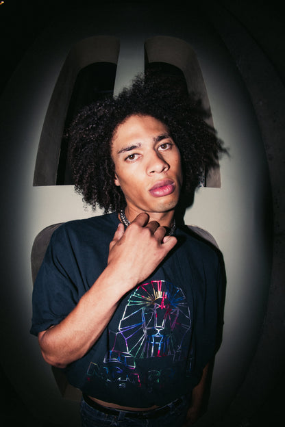 A young man with an afro posing for a picture.