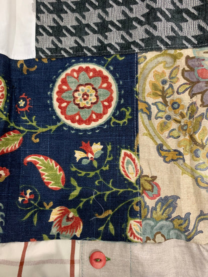 A patchwork quilt with floral designs.
