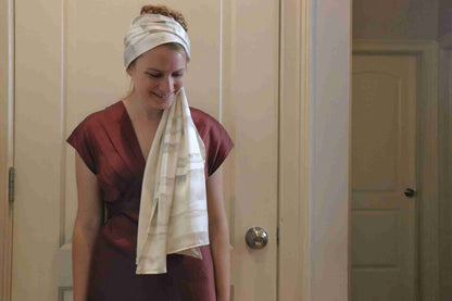a woman with a towel wrapped around her head.