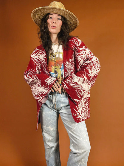 A woman in jeans and a hat is posing for a photo.
