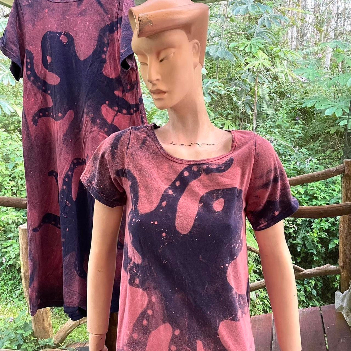 a mannequin wearing a t - shirt with a design on it.
