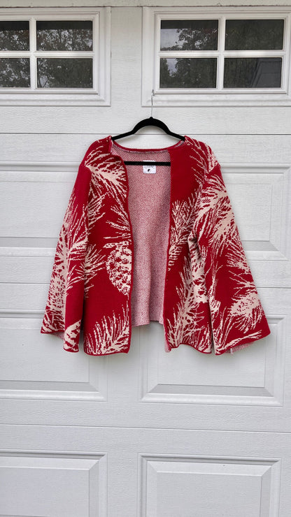 A red and white jacket hanging on a garage door.