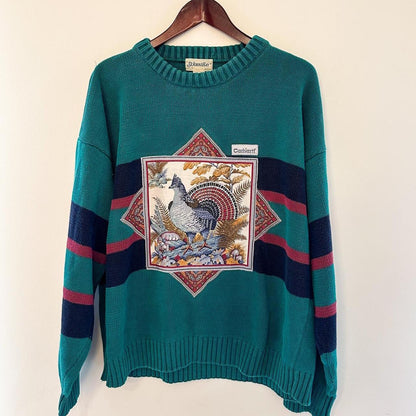 A green sweater with an image of a turkey on it.