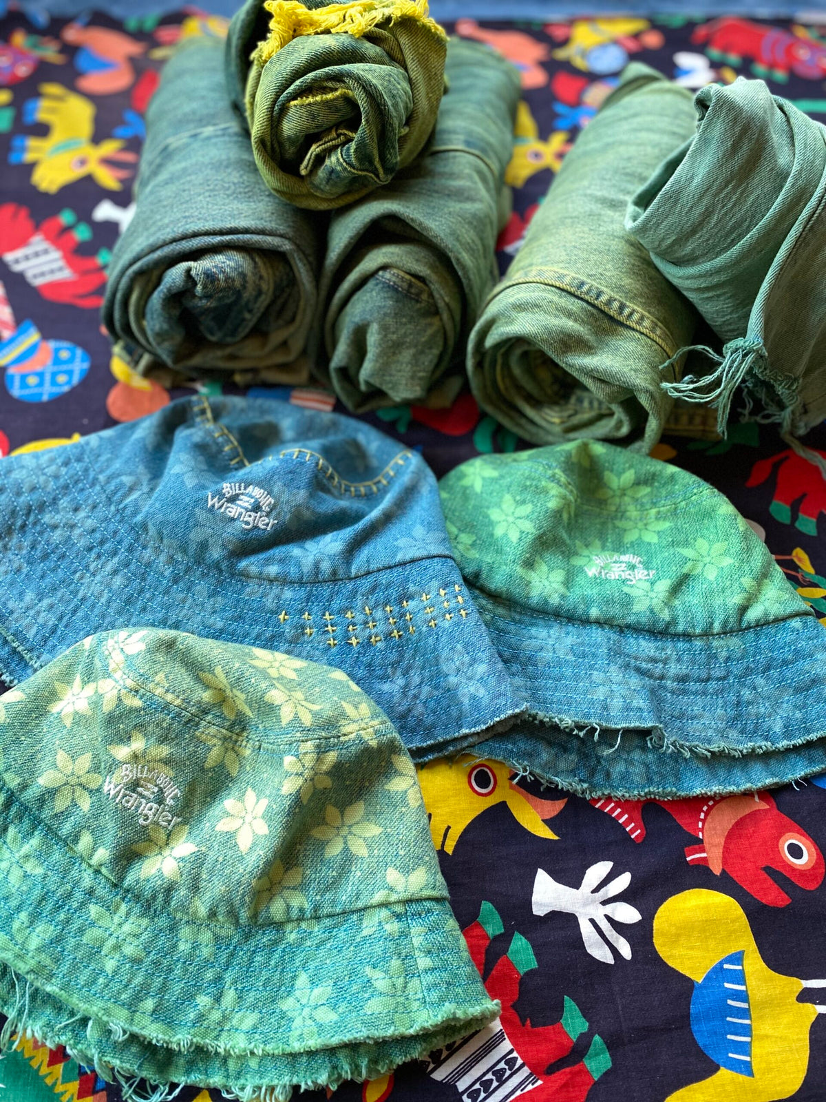 A group of hats and blankets laid out on a table.