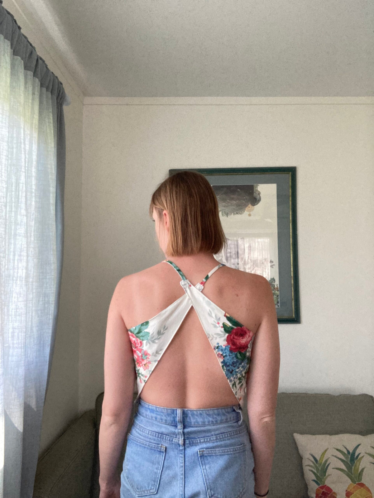 The back of a woman wearing a floral top.