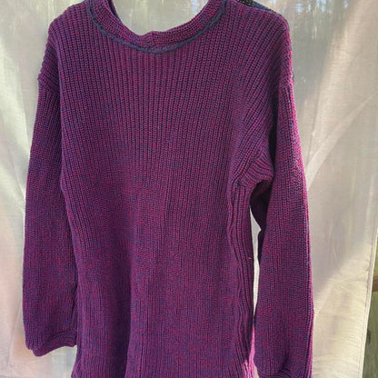 A purple sweater hanging on a mannequin.