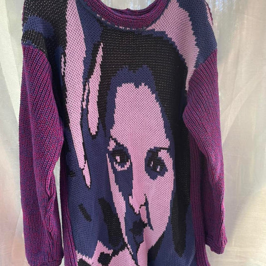 A sweater with a woman's face on it.
