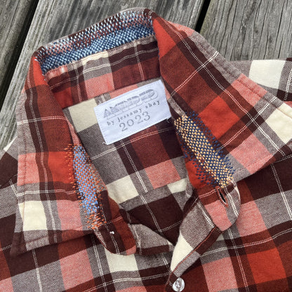 A plaid shirt on a wooden deck.