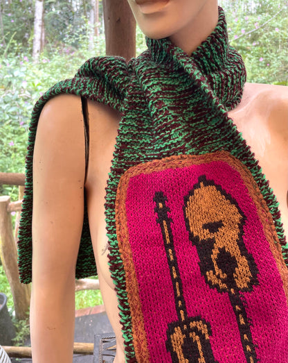A mannequin wearing a scarf with a guitar on it.