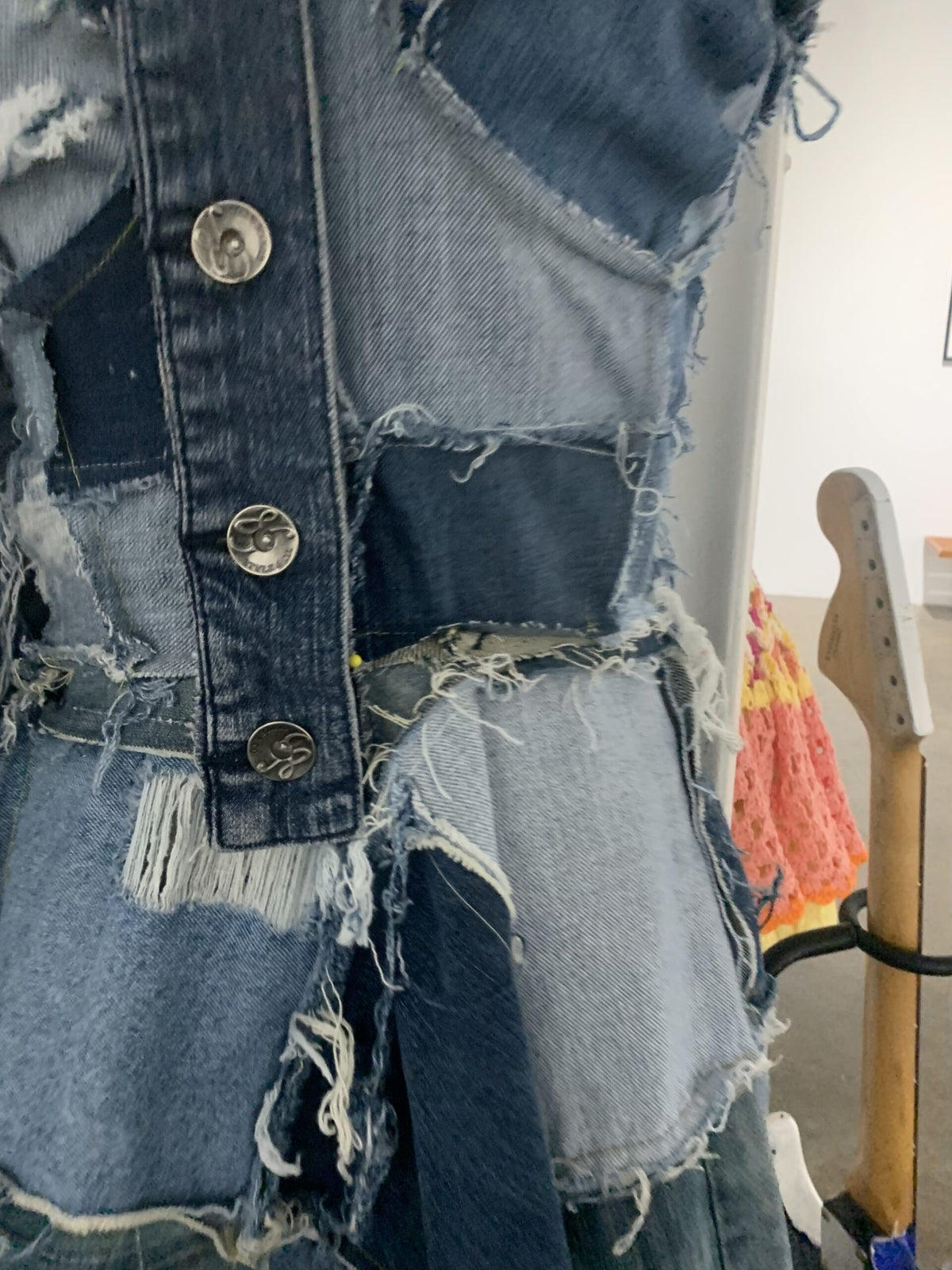 a blue denim jacket is on display in a room.