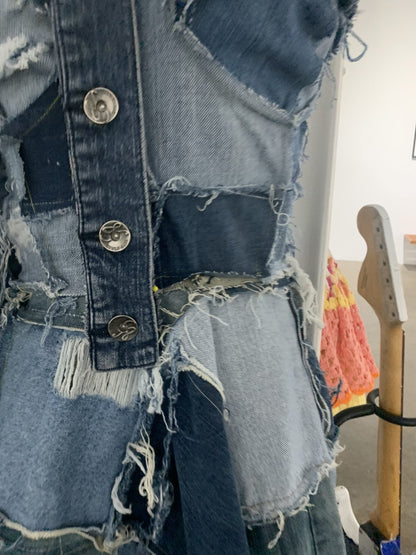 a blue denim jacket is on display in a room.