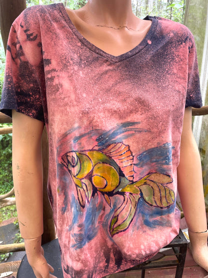 A mannequin wearing a t - shirt with a fish on it.