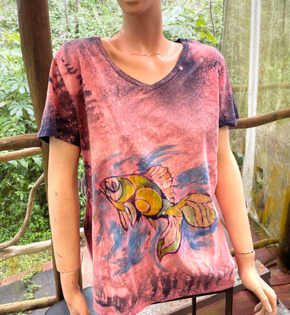 A mannequin wearing a t - shirt with a fish on it.