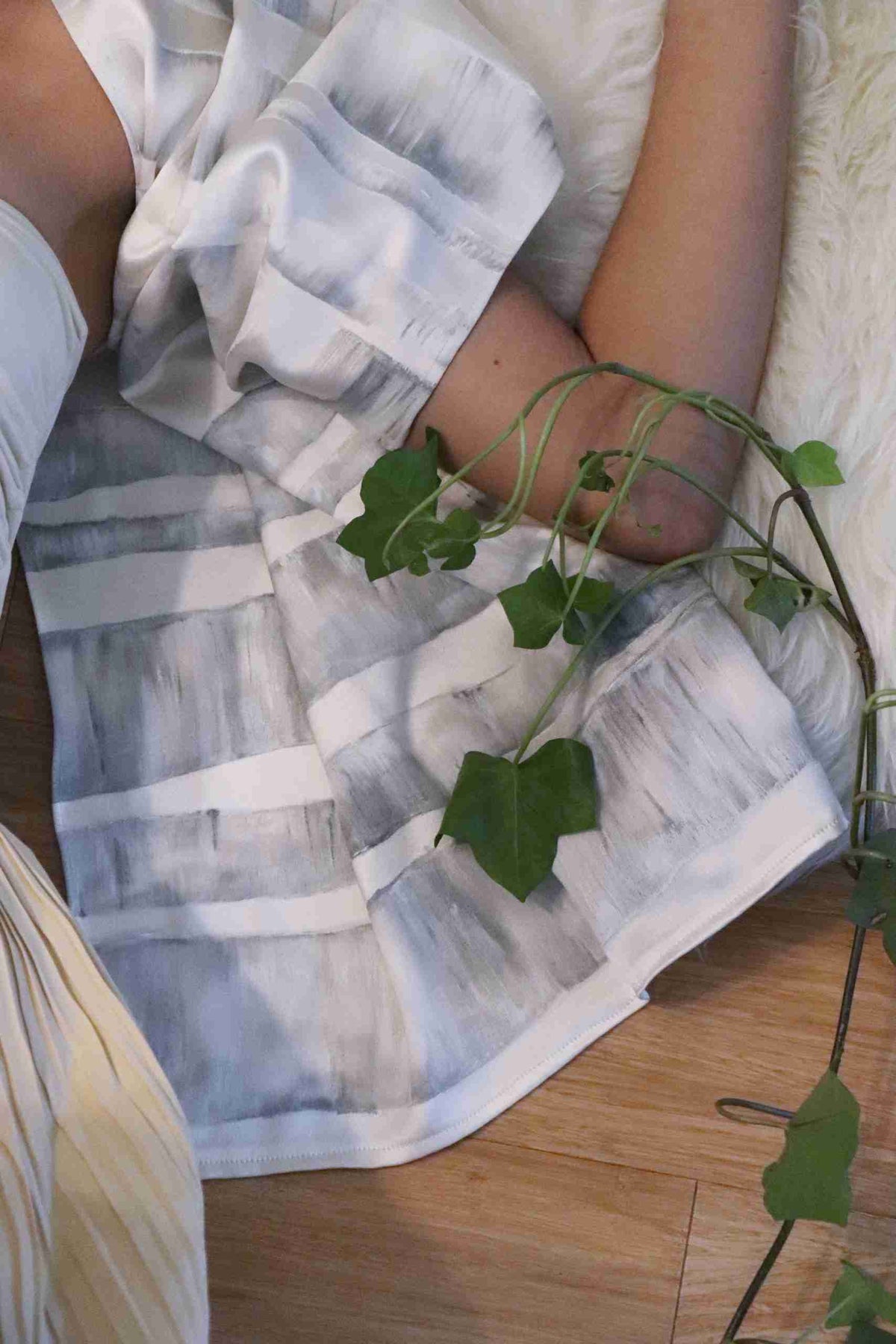 a person laying on a bed with a plant in their lap.