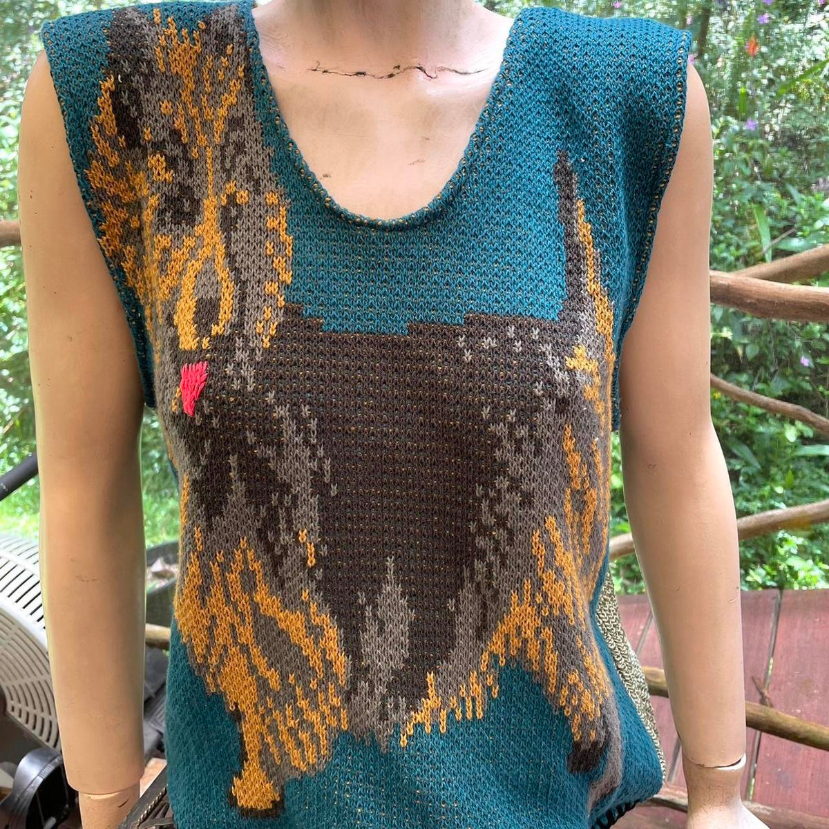 A woman wearing a sweater with a dog on it.