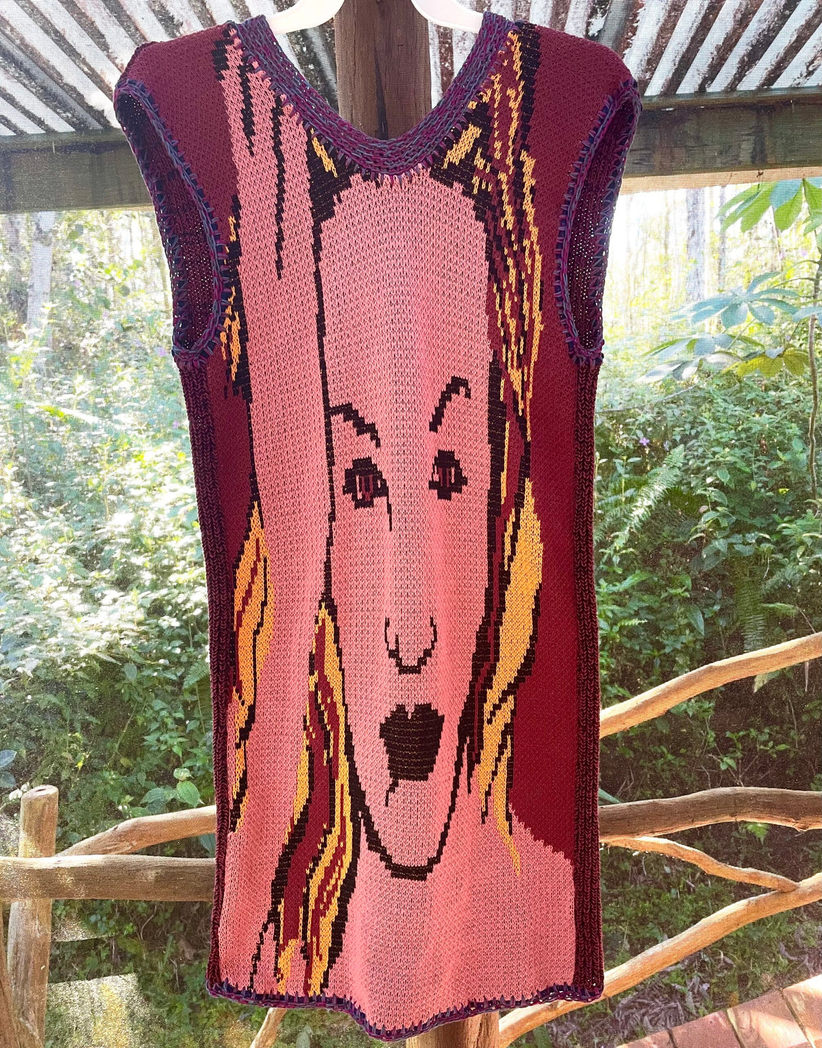 A knitted sweater with a woman's face on it.