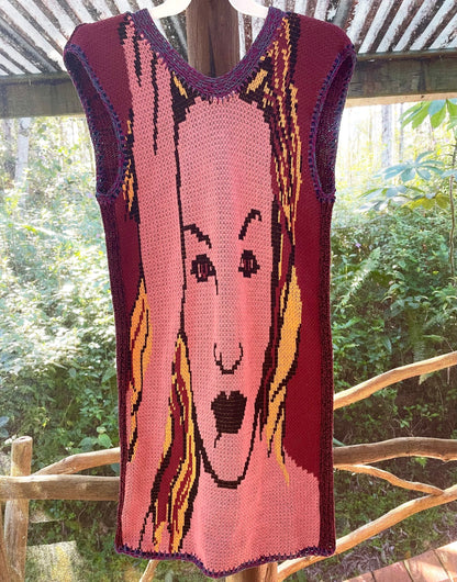 A knitted sweater with a woman's face on it.